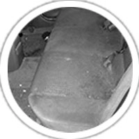 A close-up of a dirty car seat with visible stains and debris, highlighting the need for deep cleaning.