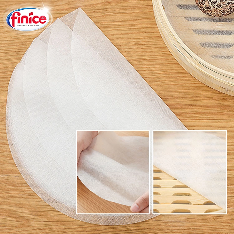 Close-up of Finice round steaming cloth, made from breathable, non-stick material, placed on a bamboo steamer for dumplings and buns.